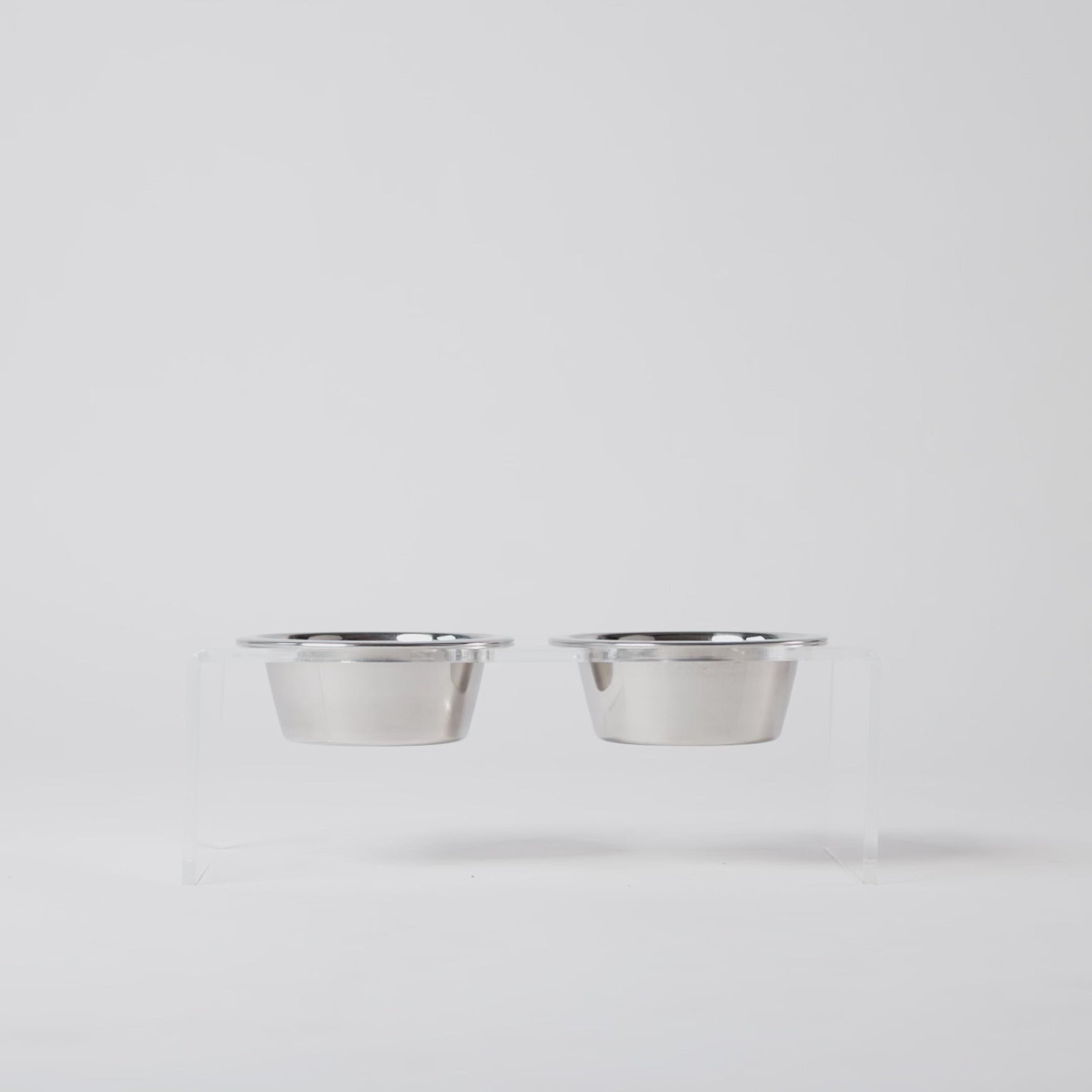 Two removable dishwasher-safe stainless steel bowl inserts for acrylic elevated pet feeder