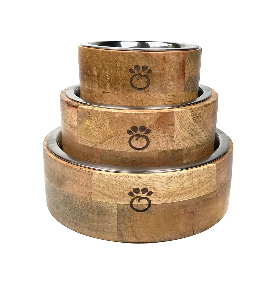GF Pet mango wood pet bowls in three sizes S M L stacked together showing natural wood grain variation and paw logos