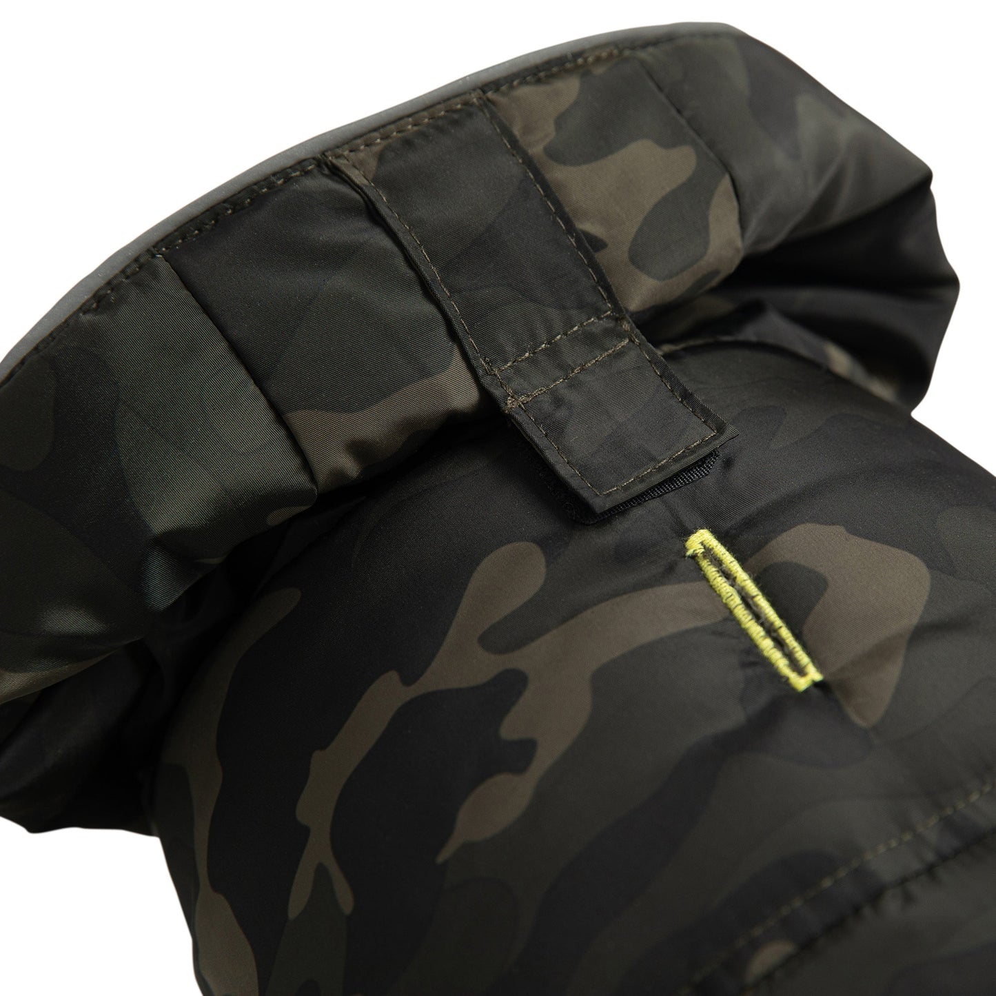 Detail view of GF Pet camouflage recycled parka hood closure showing Velcro fastener and neon yellow accent zipper pull