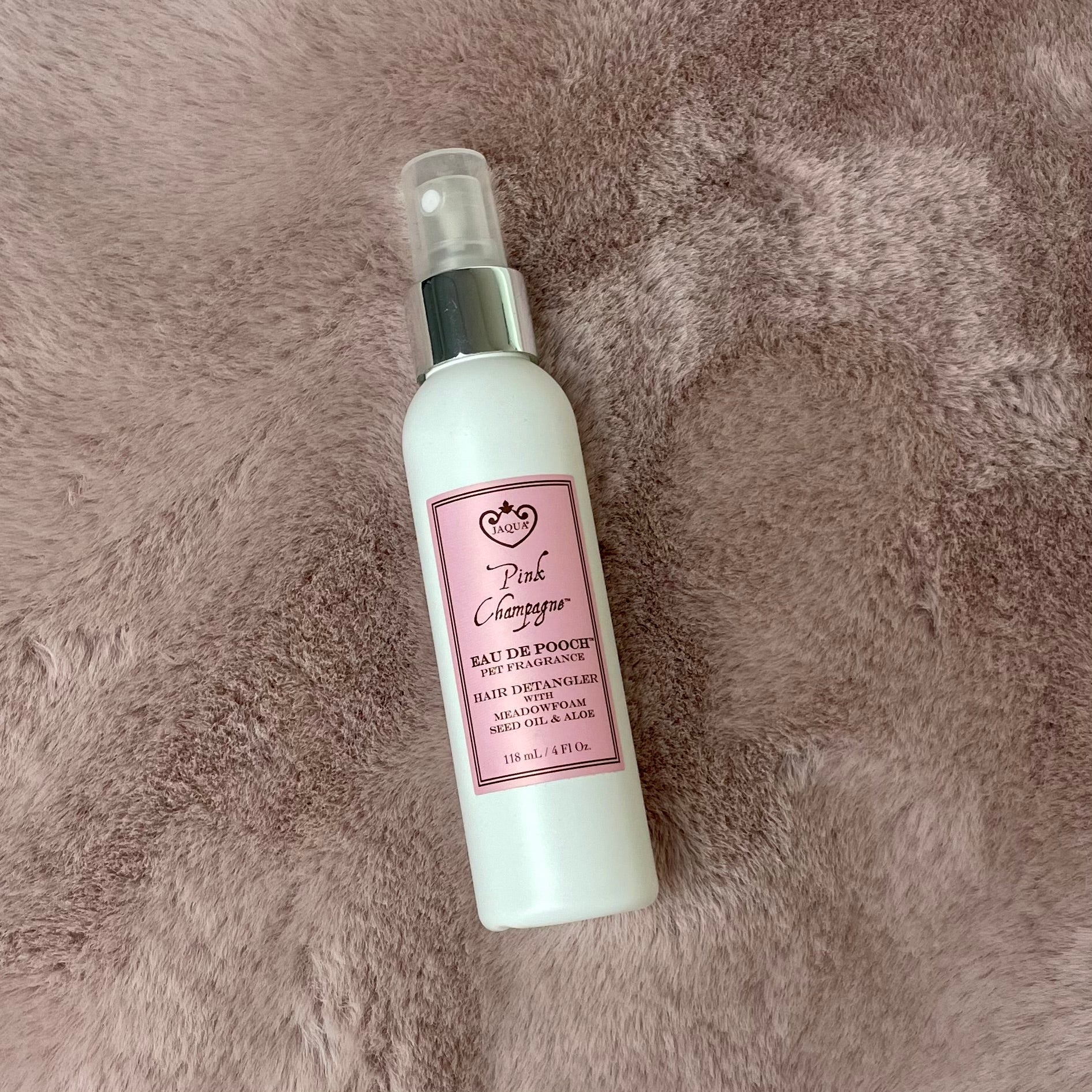 Pink Champagne peTabby cat with Pink Champagne pet fragrance spray bottlet fragrance spray bottle on soft pink fluffy background lifestyle shot