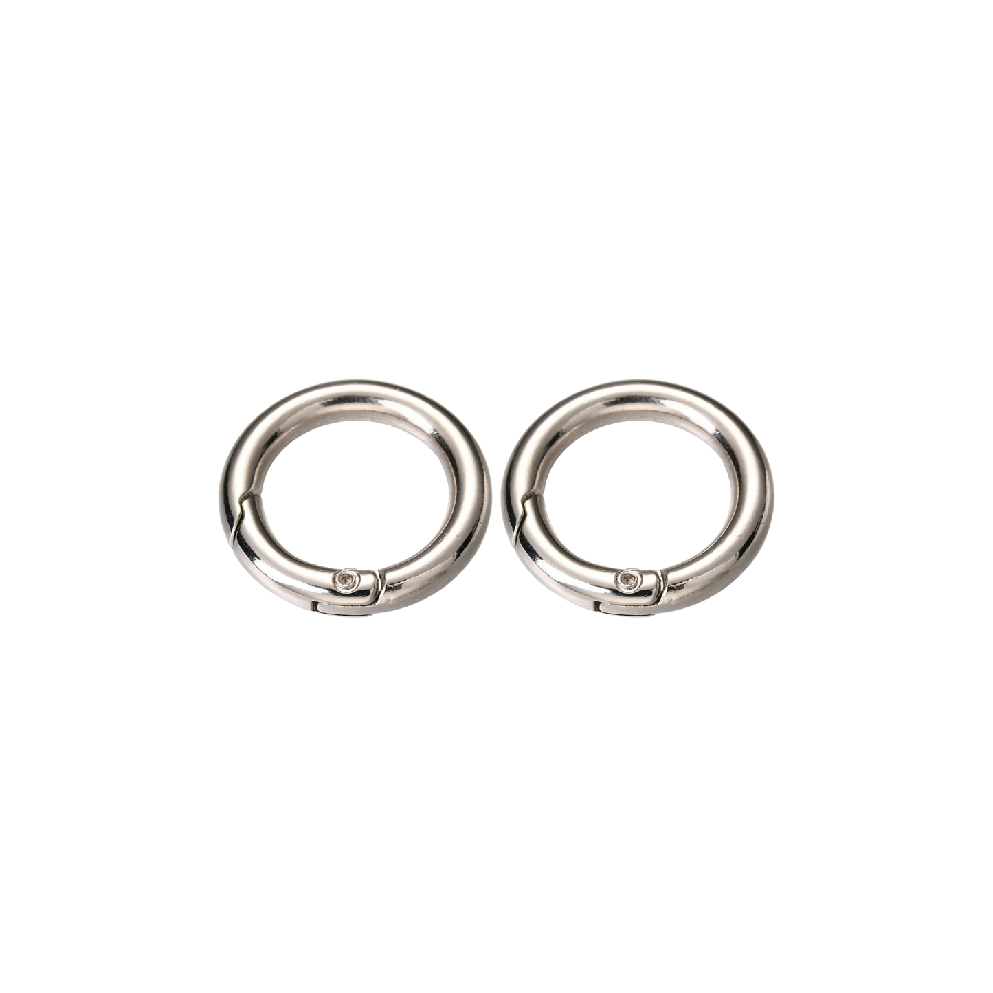 Two silver Switch-Bit quick-release dog tag keepers with spring-loaded gates on transparent background